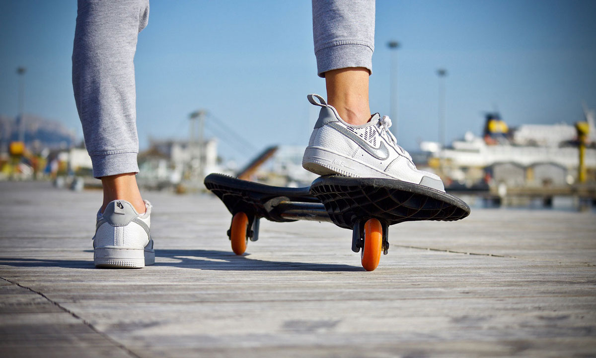 skateboarder using anelectric skateboard on the boardwalk