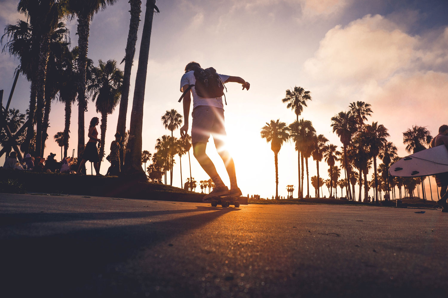 a man skateboarding at sunset
